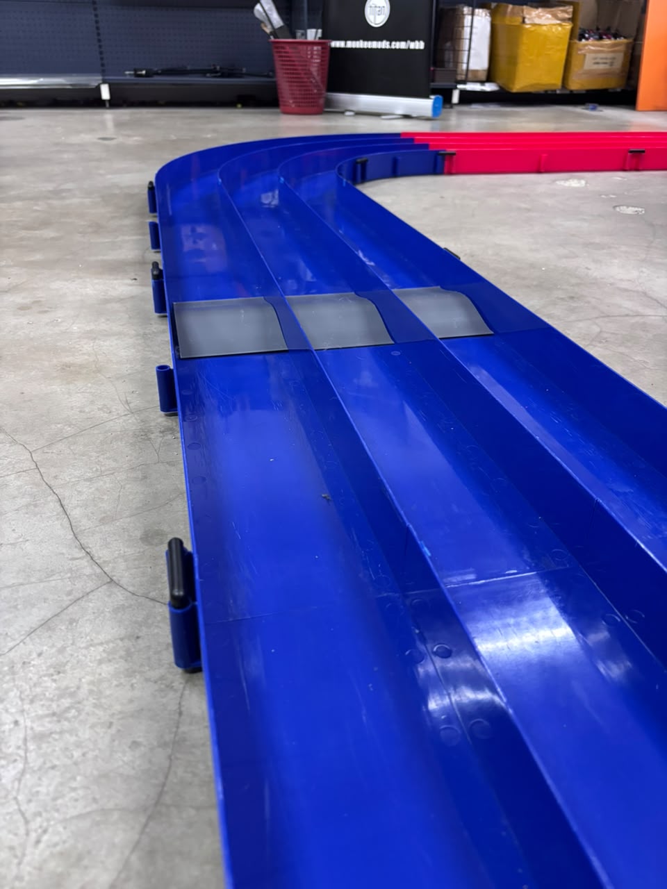 Close view of a ramp section on the blue Mini 4WD track at Monkee Mods