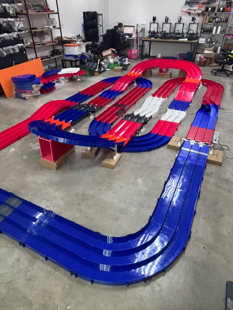 Expanded red and blue Mini 4WD track at Monkee Mods, showing raised sections, slopes and turns from the side