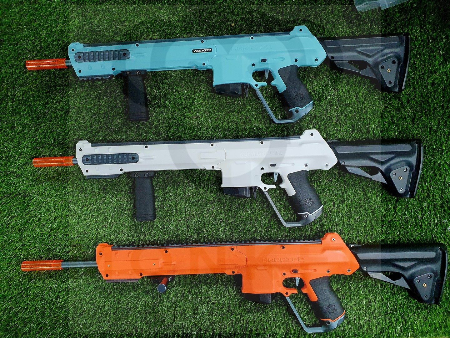 Three Worker Harrier foam dart blasters on green turf